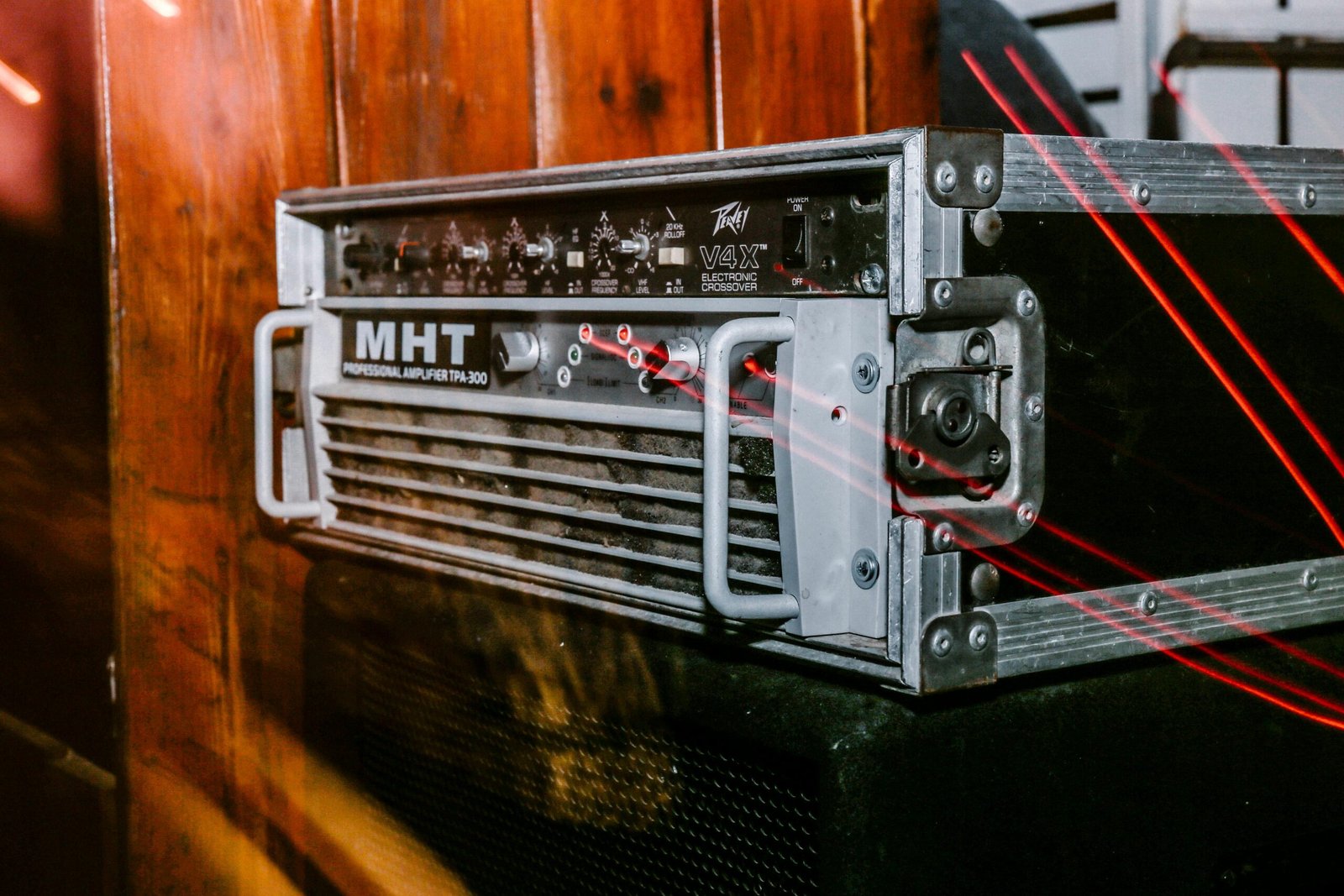 Detailed close-up of a retro MHT audio amplifier inside a metal case, highlighting vintage electronic design.